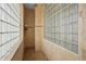 Elegant bathroom featuring walk-in shower with glass block and decorative tile accents at 7025 Saddle Creek Cir, Sarasota, FL 34241