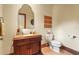 Elegant half bathroom features custom vanity with carved details, decorative mirror, and beautiful wall accents at 7025 Saddle Creek Cir, Sarasota, FL 34241