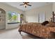 Spacious bedroom featuring a ceiling fan, built-in shelving and natural lighting at 7025 Saddle Creek Cir, Sarasota, FL 34241
