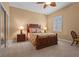 Cozy bedroom with neutral walls, carpet flooring, and a traditional-style wooden bed frame at 7025 Saddle Creek Cir, Sarasota, FL 34241