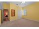 Bright bedroom with neutral carpet, closet doors, and a window featuring shutter-style blinds at 7025 Saddle Creek Cir, Sarasota, FL 34241