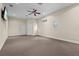 Versatile bonus room featuring neutral carpet, ceiling fan, and natural light at 7025 Saddle Creek Cir, Sarasota, FL 34241