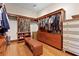 Walk-in closet with wood floors offers custom shelves, drawers, and hanging rods for optimal storage at 7025 Saddle Creek Cir, Sarasota, FL 34241