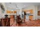 Eat-in kitchen with terracotta tile floors, stainless steel appliances, wooden cabinets, and backyard views at 7025 Saddle Creek Cir, Sarasota, FL 34241