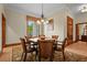 Dining room with ornate chandelier and rug with access to carved wooden door at 7025 Saddle Creek Cir, Sarasota, FL 34241