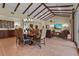 Spacious dining room adjacent to living room with high ceilings and decorative wood beams at 7025 Saddle Creek Cir, Sarasota, FL 34241