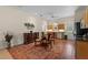 Dining room with beautiful terracotta floors, wooden table and chairs, and decorative greenery at 7025 Saddle Creek Cir, Sarasota, FL 34241