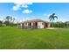 Exterior view of horse stables with a red tile roof and well-maintained grounds at 7025 Saddle Creek Cir, Sarasota, FL 34241