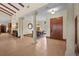 Spacious foyer with decorative columns, tile flooring, and an ornate front door at 7025 Saddle Creek Cir, Sarasota, FL 34241