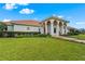 Beautiful front yard with lush lawn and manicured shrubs leading up to the front entrance at 7025 Saddle Creek Cir, Sarasota, FL 34241