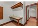 Hallway desk area with decorative wood trim, granite countertop and adjacent archway into the hallway at 7025 Saddle Creek Cir, Sarasota, FL 34241
