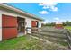 Exterior of a horse stable with stalls and a wooden fence at 7025 Saddle Creek Cir, Sarasota, FL 34241