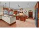Gourmet kitchen features stainless steel appliances, a granite island, and a tiled backsplash at 7025 Saddle Creek Cir, Sarasota, FL 34241