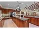 Spacious kitchen with wood cabinetry, an island with granite countertops, and stainless steel appliances at 7025 Saddle Creek Cir, Sarasota, FL 34241
