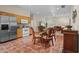 Eat-in kitchen with terracotta tile flooring, stainless steel appliances, and wood cabinetry at 7025 Saddle Creek Cir, Sarasota, FL 34241