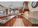 Well-appointed kitchen features a center island, custom cabinetry, and views to the outdoor spaces at 7025 Saddle Creek Cir, Sarasota, FL 34241