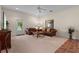 Comfortable living room with neutral colored carpet, furnishings, decor and access to the outdoor patio at 7025 Saddle Creek Cir, Sarasota, FL 34241