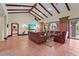 Bright living room featuring vaulted ceilings, tile floors, and access to a patio at 7025 Saddle Creek Cir, Sarasota, FL 34241