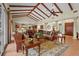 Open-concept living space featuring vaulted ceilings, exposed beams and neutral color palette at 7025 Saddle Creek Cir, Sarasota, FL 34241