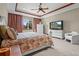 Comfortable main bedroom with large window, carpet and ceiling fan at 7025 Saddle Creek Cir, Sarasota, FL 34241