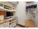 Home office area with a desk, corkboard and shelving unit for organization at 7025 Saddle Creek Cir, Sarasota, FL 34241