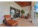Relaxing covered patio with wicker furniture, lounge chairs, and views of the property at 7025 Saddle Creek Cir, Sarasota, FL 34241
