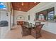 Covered patio with seating, a summer kitchen and tiled floors, perfect for outdoor entertaining at 7025 Saddle Creek Cir, Sarasota, FL 34241