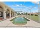 A large screened-in pool is surrounded by a brick patio at 7025 Saddle Creek Cir, Sarasota, FL 34241