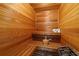 An indoor sauna features wooden benches, walls, and a bucket for a relaxing and therapeutic experience at 7025 Saddle Creek Cir, Sarasota, FL 34241