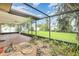 Enclosed tile patio and backyard featuring green space, garden and palm trees at 7401 3Rd Nw Ave, Bradenton, FL 34209
