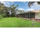 Expansive backyard showcasing a large, well-maintained lawn and a screened-in patio for relaxation and entertainment at 7401 3Rd Nw Ave, Bradenton, FL 34209
