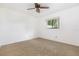 Bright bedroom with neutral carpet, a ceiling fan, and view from the window at 7401 3Rd Nw Ave, Bradenton, FL 34209