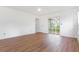 Light-filled bedroom with wood-look floors, and a sliding glass door to a patio at 7401 3Rd Nw Ave, Bradenton, FL 34209