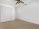 Carpeted bedroom featuring a ceiling fan and double door closet at 7401 3Rd Nw Ave, Bradenton, FL 34209