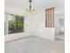 The dining room features tile floors, a chandelier, and a window offering an outdoor view at 7401 3Rd Nw Ave, Bradenton, FL 34209
