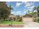 Single-story home with a well-kept lawn, stone accents, and mature landscaping at 7401 3Rd Nw Ave, Bradenton, FL 34209