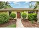 Charming front entrance with a well-maintained walkway and lush landscaping at 7401 3Rd Nw Ave, Bradenton, FL 34209
