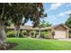 Inviting home exterior with mature trees, manicured lawn, and charming stone accents at 7401 3Rd Nw Ave, Bradenton, FL 34209