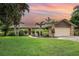 Charming single-story home with a well-manicured lawn and tropical landscaping at 7401 3Rd Nw Ave, Bradenton, FL 34209