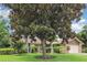 Beautiful home exterior with a lush green lawn and mature magnolia tree at 7401 3Rd Nw Ave, Bradenton, FL 34209