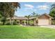Charming single-story home with a well-manicured lawn and tropical landscaping at 7401 3Rd Nw Ave, Bradenton, FL 34209