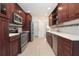 Beautiful galley kitchen boasts stainless steel appliances, custom cabinets, and light countertops at 7401 3Rd Nw Ave, Bradenton, FL 34209