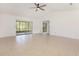 Spacious living room with tile floors, a ceiling fan, and a sliding glass door at 7401 3Rd Nw Ave, Bradenton, FL 34209