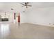 Large living room with tile floors, ceiling fan, and open entryway at 7401 3Rd Nw Ave, Bradenton, FL 34209