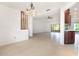 Open-concept living room and dining area with neutral tones, tile flooring and sliding glass doors to a patio at 7401 3Rd Nw Ave, Bradenton, FL 34209
