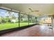Enclosed tile patio with ceiling fans and a view of the backyard at 7401 3Rd Nw Ave, Bradenton, FL 34209
