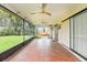 Enclosed tile patio with ceiling fans and view of green yard at 7401 3Rd Nw Ave, Bradenton, FL 34209