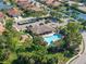 Aerial view of community pool, playground, and clubhouse with mature landscaping at 7403 Hamilton Rd, Bradenton, FL 34209