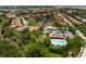 An aerial view shows a vibrant community with a central lake, lush landscaping, and community pool at 7403 Hamilton Rd, Bradenton, FL 34209