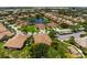 An aerial view of the community featuring a centrally located pond and mature trees throughout at 7403 Hamilton Rd, Bradenton, FL 34209